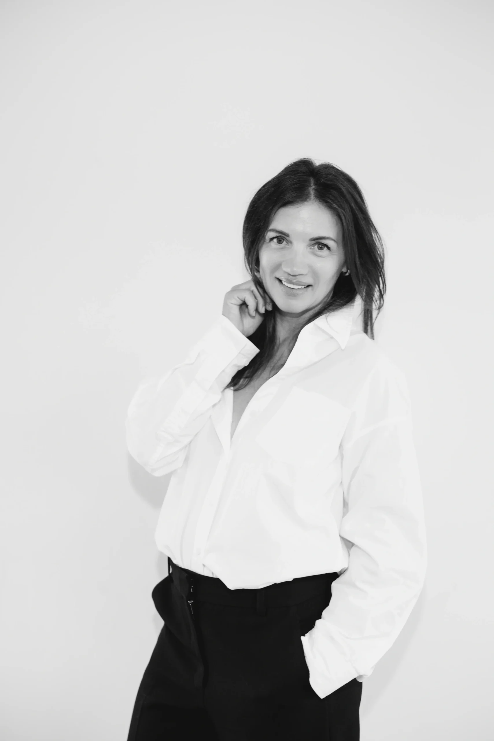 DHC Insights founder in a white shirt, photographed in black and white.